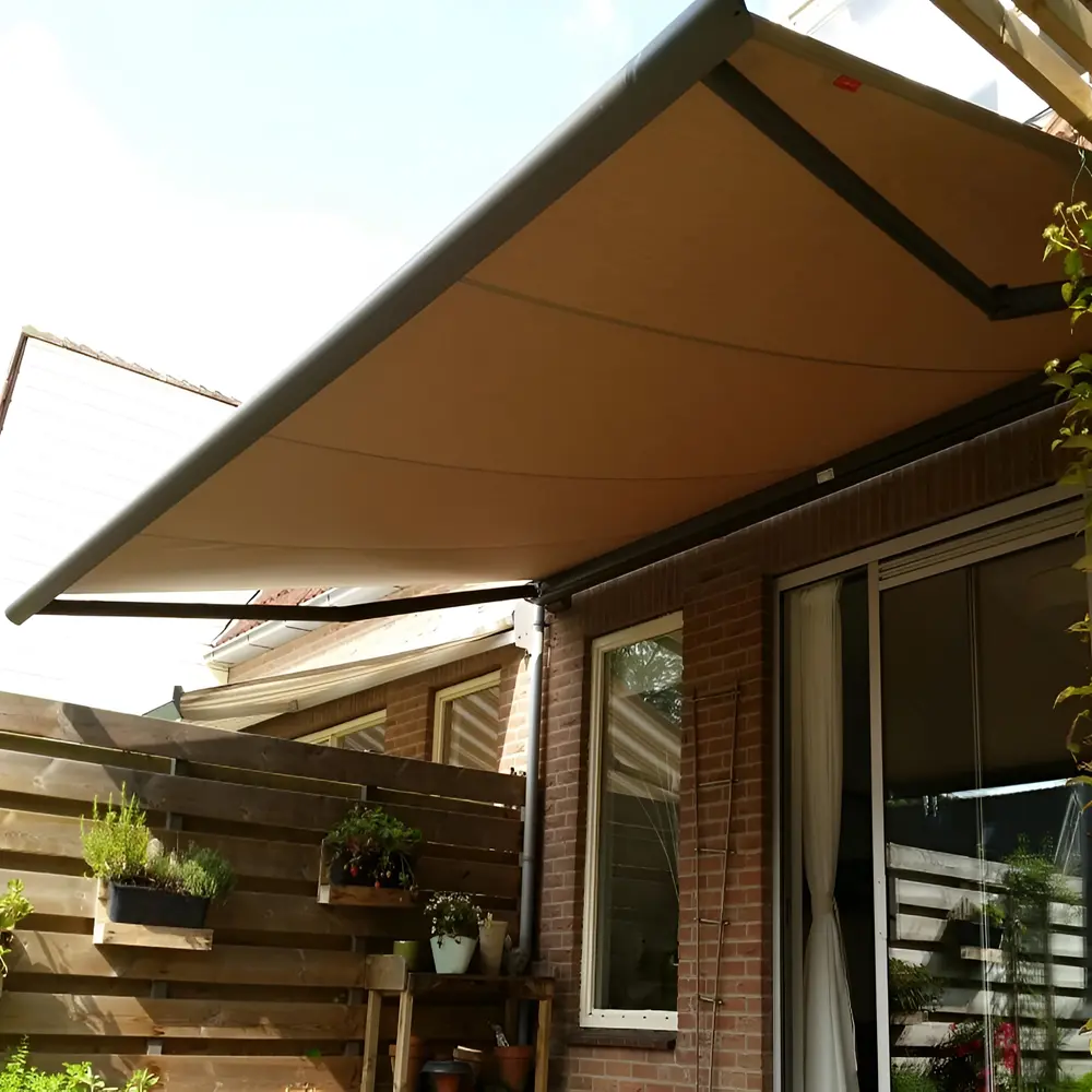 Cassita II zonnescherm uitgeklapt boven terras tegen een bakstenen muur