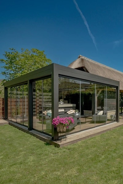 Lamellen tuinkamer Varia met glazen wanden en rieten dak in tuin Lamellen tuinkamer Varia met glazen wanden en rieten dak in tuin