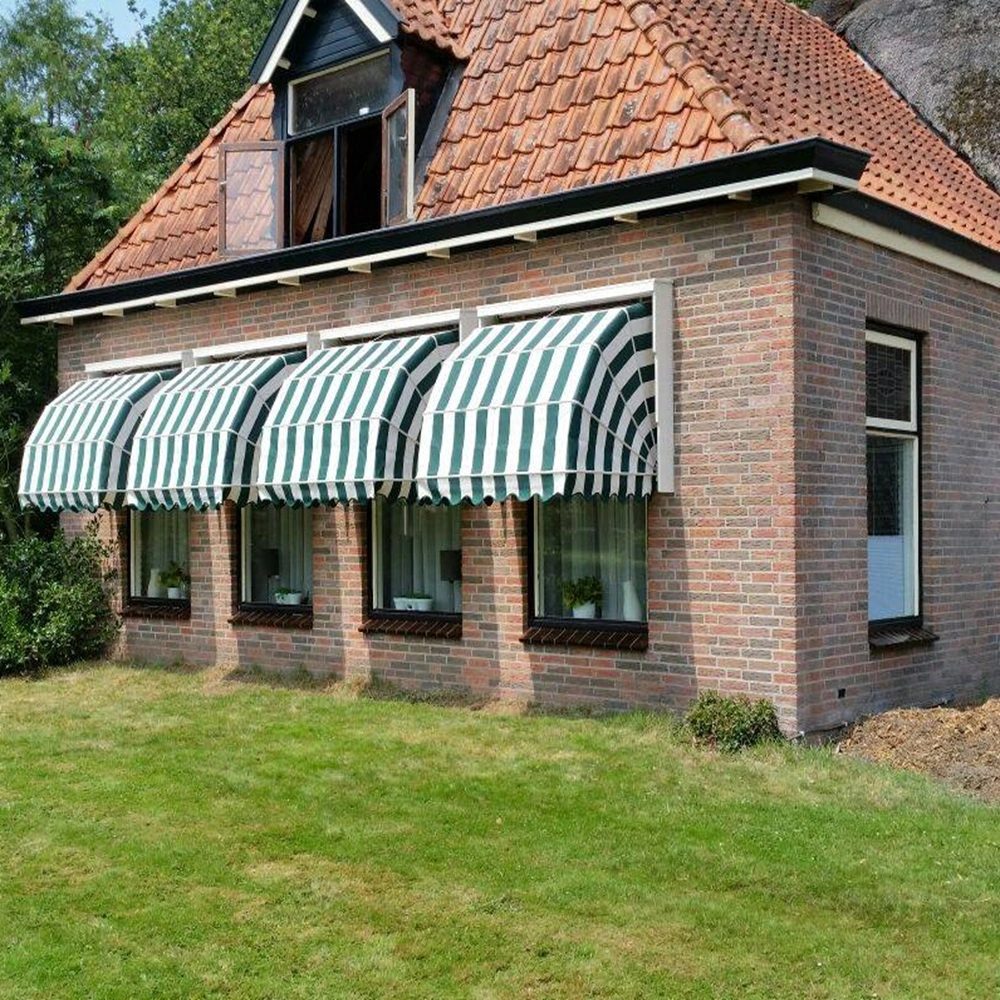 Houten markies met groen-witte strepen op bakstenen huis met drie ramen