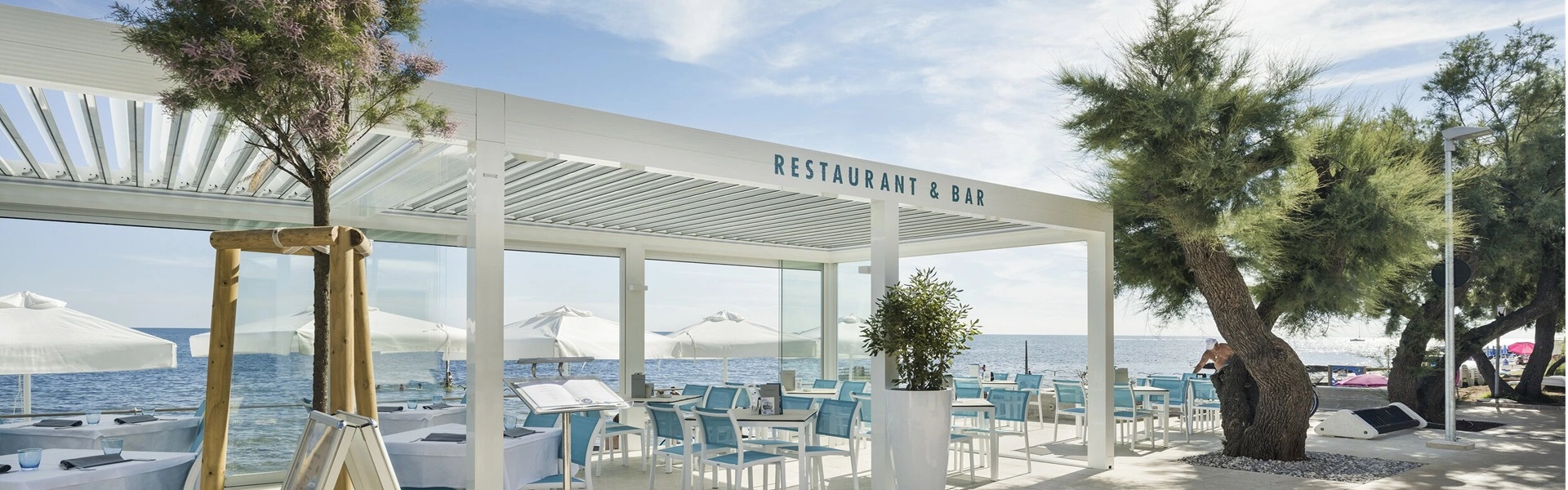 Overkapping bij hotelrestaurant met terras direct aan zee