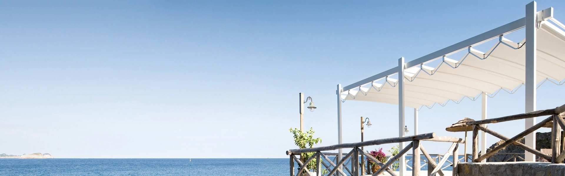 Vrijstaande Isola Fly zonwering op klif met uitzicht op zee