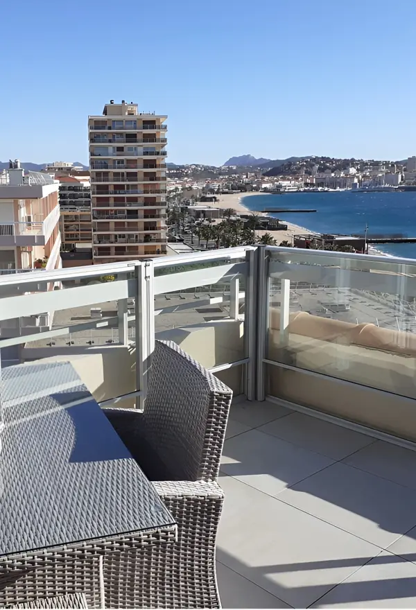 Glazen windschermen op balkon in Italië bieden bescherming en uitzicht op zee