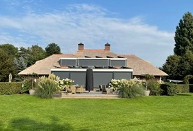 Grote screens op boerderijwoning met ruime tuin