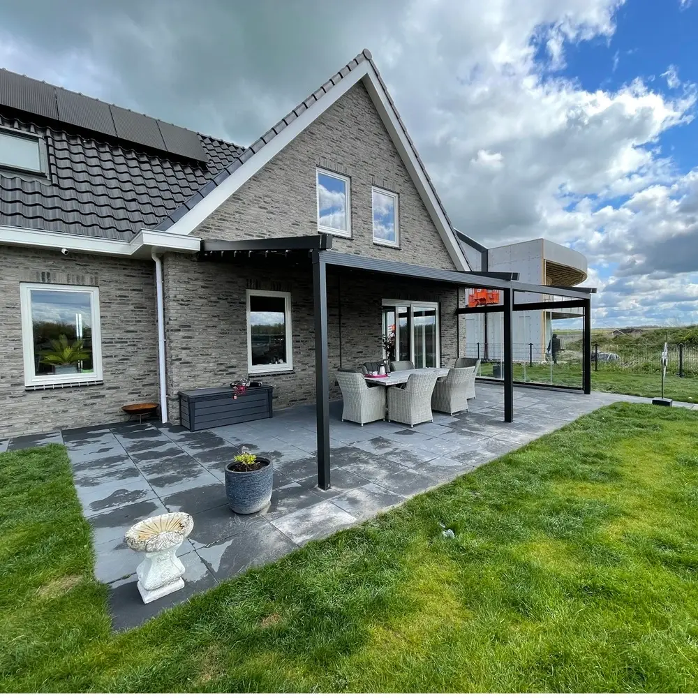 Veldman Zonwering terrasoverkapping met glazen schuifwanden in tuin in Leeuwarden